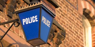 Police lamp against brick wall