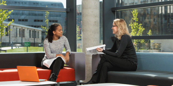 Joan Loughrey with a student in the Liberty Building foyer